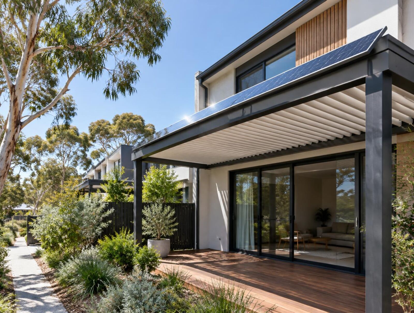 Modern townhouse terrace with a slim solar panel along the pergola edge